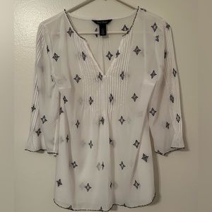 White House/Black Market Woman’s Top. Sheer White with Black accents. Size 4